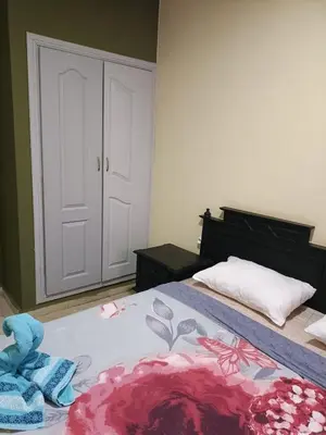 a bedroom with a bed with towels on it at family apartment 06 in Marrakech