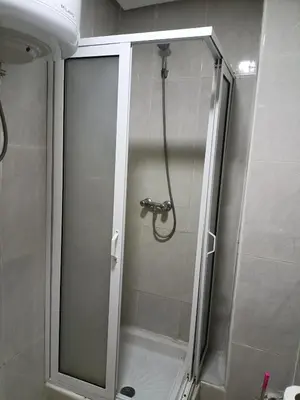 a shower with a glass door in a bathroom at family apartment 06 in Marrakech