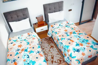 two beds sitting next to each other in a bedroom at Appartement Marrakech in Marrakech