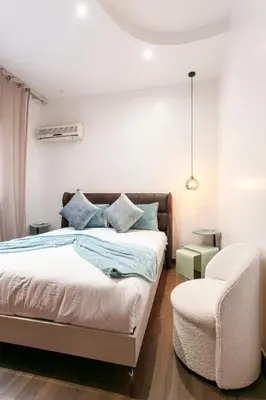 a bedroom with a bed and a chair at Prestige Zone Marrakech in Marrakech