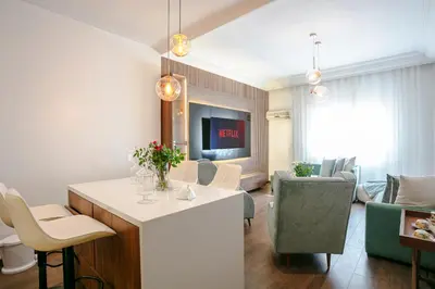 a living room with a kitchen and a living room with a couch at Prestige Zone Marrakech in Marrakech
