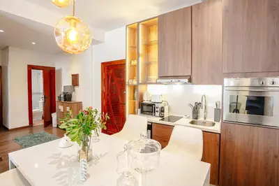 a kitchen with a table with chairs and a microwave at Prestige Zone Marrakech in Marrakech