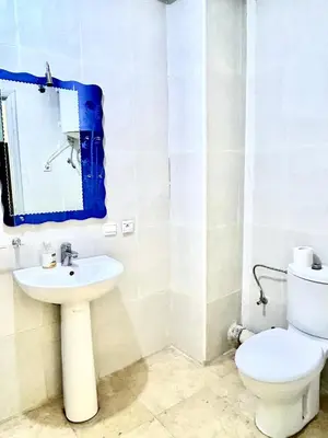 a bathroom with a toilet and a sink at imm O Family apartment 7 in Marrakech