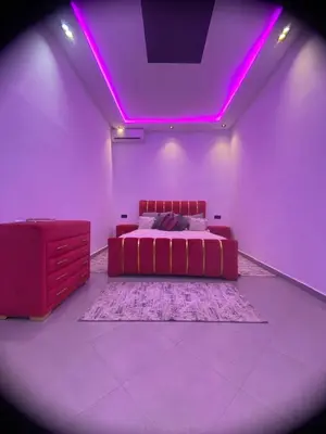 a bedroom with a bed and purple lighting at Waha hassan 2 in Marrakech