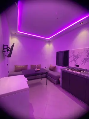a purple living room with a couch and a tv at Waha hassan 2 in Marrakech