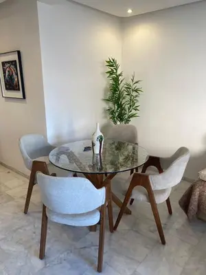 a dining room with a glass table and chairs at Cozy apartment with pool Bd Mohamed 6 in Marrakech