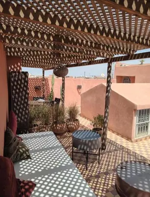 a patio with tables and chairs on a patio at SAMA DABACHI Vibrant Medina Loft and Roof top in Marrakech