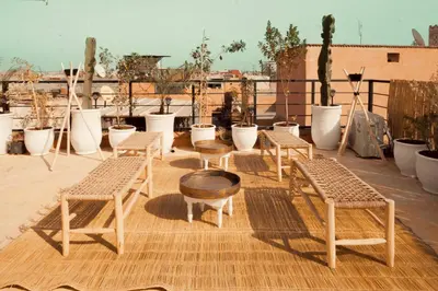 a group of chairs and tables on a roof at Savor Home Authentic Entire Riad with Medina View & Terrace in Marrakech