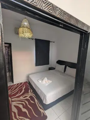 a bedroom with a bed and a chandelier at Almohafidon room in Marrakech