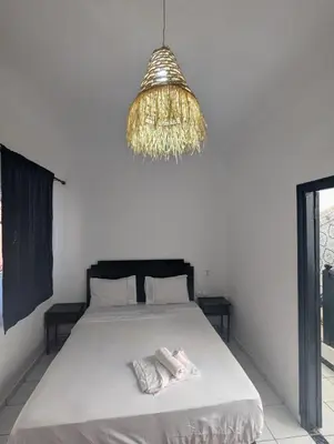 a bedroom with a bed and a chandelier at Almohafidon room in Marrakech