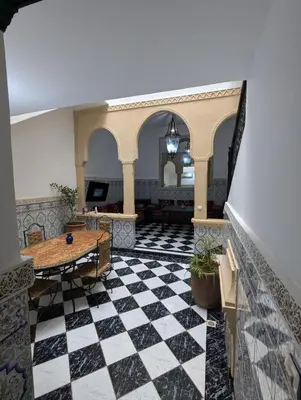 a lobby with a black and white checkered floor at Almohafidon room in Marrakech
