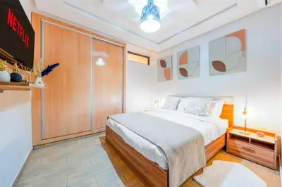 a bedroom with a bed and a large closet at Comfort and Serenity in the Center of Marrakech in Marrakech