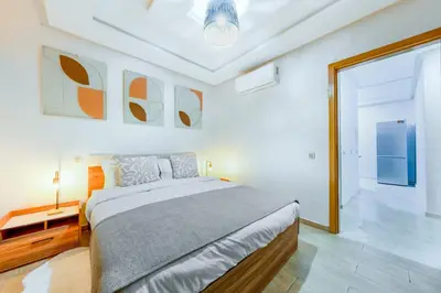 a white bedroom with a large bed and a window at Comfort and Serenity in the Center of Marrakech in Marrakech