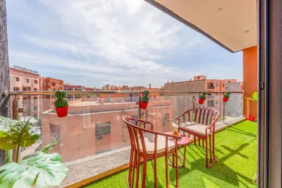 a balcony with two chairs and a table on a roof at Comfort and Serenity in the Center of Marrakech in Marrakech