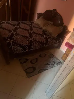 a bedroom with a bed with a rug on the floor at Aéroport Menara marrakech in Marrakech