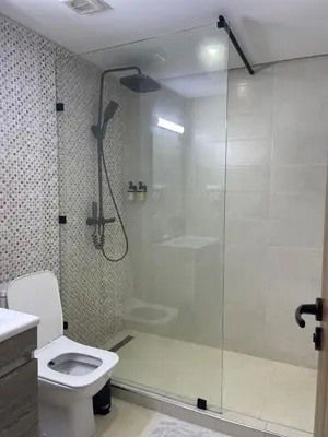 a bathroom with a glass shower with a toilet at Home Star Luxury Apartment Marrakech in Marrakech