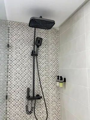 a shower with a shower head in a bathroom at Home Star Luxury Apartment Marrakech in Marrakech