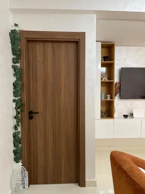 a wooden door in a living room with a television at Home Star Luxury Apartment Marrakech in Marrakech
