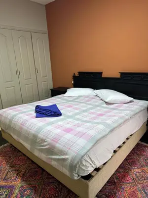 a bedroom with a bed with a blue shirt on it at apartment 9 imm O in Marrakech