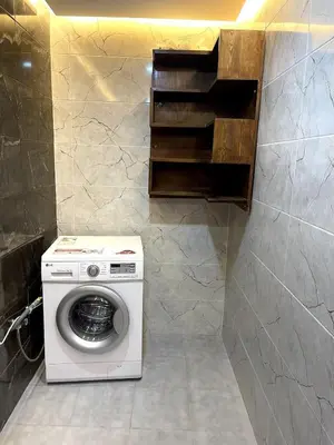 a washer and dryer in a small bathroom at Duplex Luxury Appartement in Marrakech