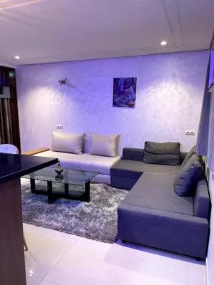 a living room with a couch and a table at Duplex Luxury Appartement in Marrakech
