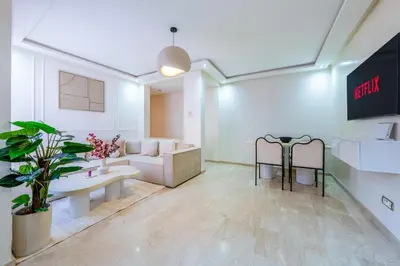 a living room with a couch and a waiting room at Downtown Gueliz Modern 1BR AC, Fast WIFI , Parking in Marrakech