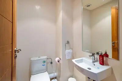 a bathroom with a white toilet and a sink at Downtown Gueliz Modern 1BR AC, Fast WIFI , Parking in Marrakech