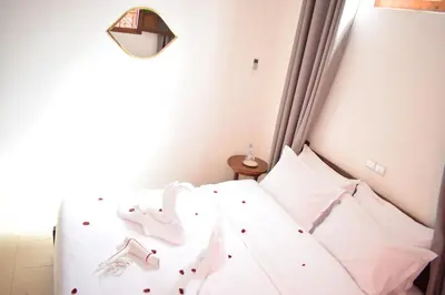 a bedroom with a white bed with an elephant headboard at Maison Marrakech in Touggana