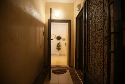 a hallway with a door and a plant in a room at Dar sultane in Marrakech