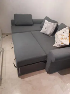a couch and a chair in a room at Opéra A Studio Apartment in Marrakech