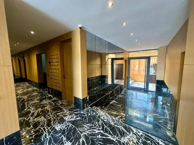a lobby with a marble floor and a room withwindows at Petit paradis près du centre in Marrakech