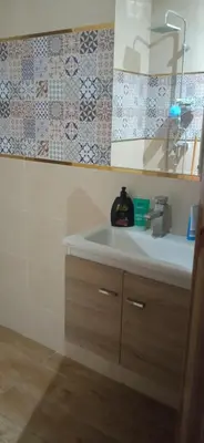 a bathroom with a sink and a mirror at appartement meublé accoté de l aéroport Marrakech in Marrakech