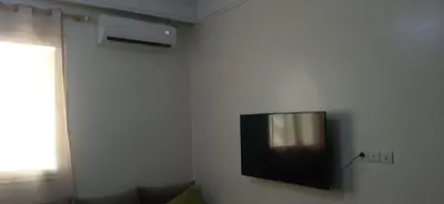 a television hanging on a wall in a room at appartement meublé accoté de l aéroport Marrakech in Marrakech