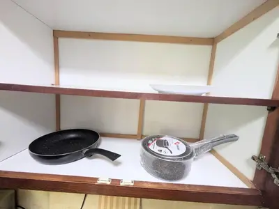 a stove with a pan and a frying pan on a shelf at Cozy studio in a good location in Marrakech