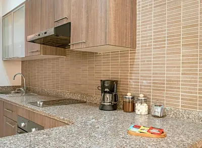 a kitchen counter top with a coffee maker on it at Luxurious Apartment in Marrakech in Dar Caïd Layadi