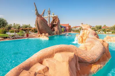 a large snake in a pool at a resort at Luxurious Apartment in Marrakech in Dar Caïd Layadi
