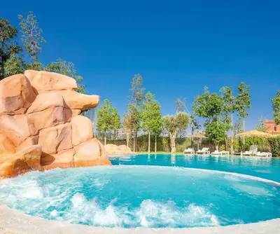 a pool at a resort with a water slide at Luxurious Apartment in Marrakech in Dar Caïd Layadi