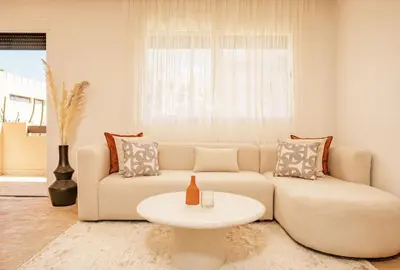 a living room with a couch and a table at Cozy & Stylish Apartment in Marrakech in Marrakech