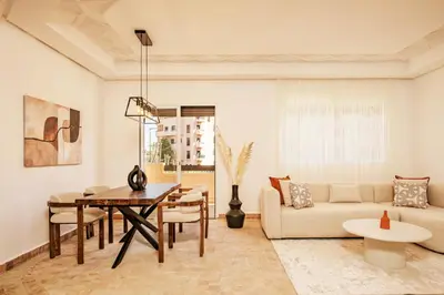 a living room with a table and a couch at Cozy & Stylish Apartment in Marrakech in Marrakech