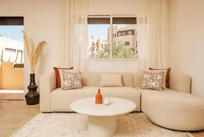 a living room with a couch and a table at Cozy & Stylish Apartment in Marrakech in Marrakech
