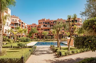 a resort with a swimming pool and some buildings at Cozy & Stylish Apartment in Marrakech in Marrakech