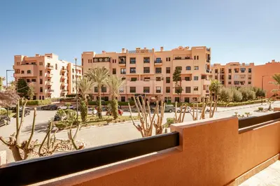 a view from a balcony of a city with buildings at Cozy & Stylish Apartment in Marrakech in Marrakech