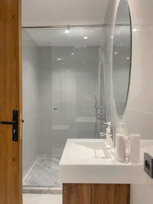 a bathroom with a sink and a shower with a mirror at Majestic Duplex - Luxe et Confort au Cœur de Marrakech in Marrakech