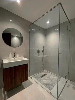a bathroom with a shower with a sink and a glass shower stall at Majestic Duplex - Luxe et Confort au Cœur de Marrakech in Marrakech