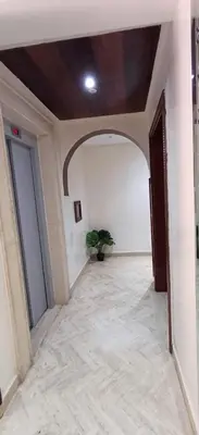 an empty hallway with a potted plant in a building at Appartement familial résidence Hamza 2 chambres in Marrakech
