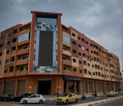 a large building with cars parked in front of it at luxurious and stylish apartment in Marrakech