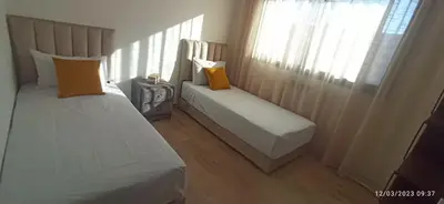 a bedroom with two beds and a tv in it at luxurious and stylish apartment in Marrakech