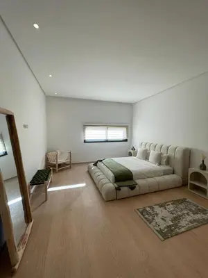 a large white bedroom with a large bed in it at Villa Rana in Marrakech