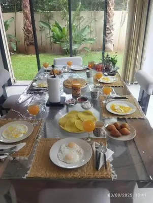 a breakfast table with eggs and food on it at Villa Rana in Marrakech