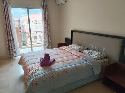 a bedroom with a bed with a stuffed animal on it at family apartment 34 in Marrakech